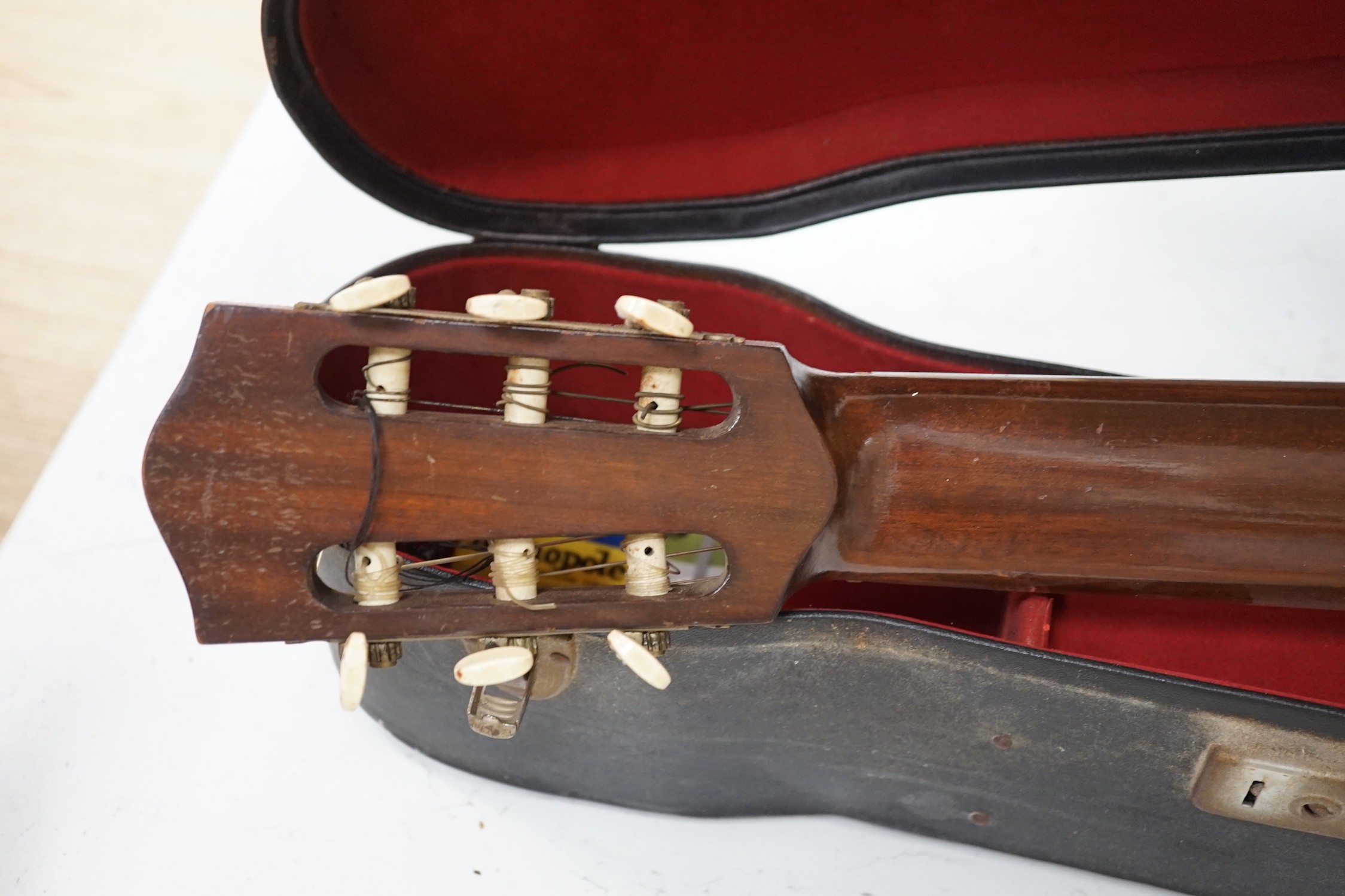 A Harald Petersen classical concert guitar, paper label interior, with hard case. Length of back 49cm excluding button
